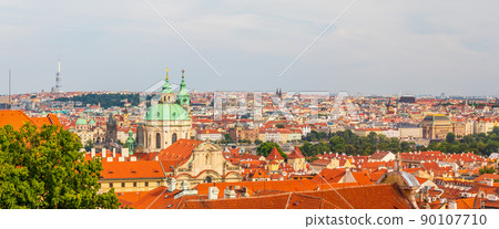 Prague cityscape panorama - city landscape with Towers of the Church of Saint Nicholas, Czech republic Prague cityscape panorama - city landscape with Towers of the Church of Saint Nicholas, Czech republic 90107710