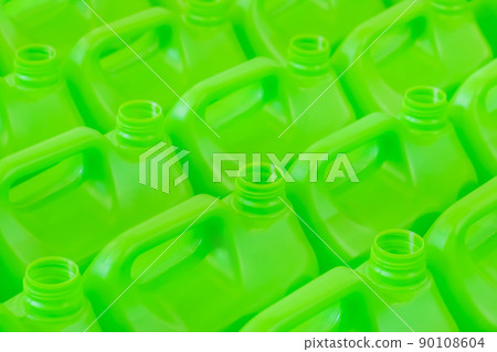 Many empty green plastic jerrycans background - close up 90108604