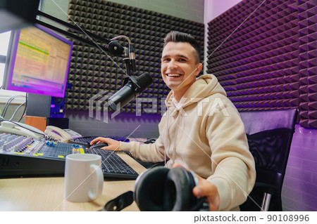 cheery radio host broadcasts live reads news on computer screen. cheery radio host broadcasts live reads news on computer screen. 90108996