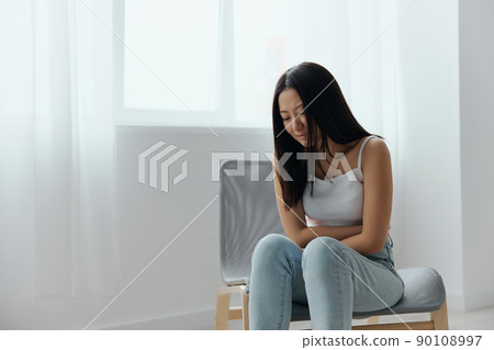Pregnancy lost. Abortion high. Tormented suffering tanned beautiful young Asian woman hold hands on stomach at home interior living room. Injuries Poor health Illness concept. Cool offer Banner Pregnancy lost. Abortion high. Tormented suffering tanned beautiful young Asian woman hold hands on stomach at home interior living room. Injuries Poor health Illness concept. Cool offer Banner 90108997