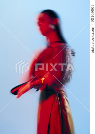 beautiful woman Glamor posing red light metal armor on hand isolated background beautiful woman Glamor posing red light metal armor on hand isolated background 90109002