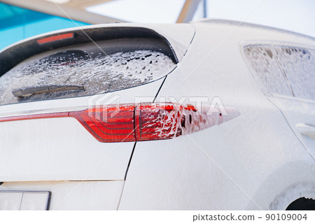 white car in foam. self-service car wash. car washer. white car in foam. self-service car wash. car washer. 90109004