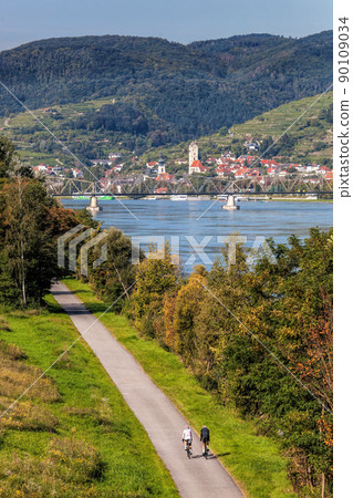 Panorama of Krems town with bikers next to Danube river in Wachau valley, Lower Austria, Austria Panorama of Krems town with bikers next to Danube river in Wachau valley, Lower Austria, Austria 90109034