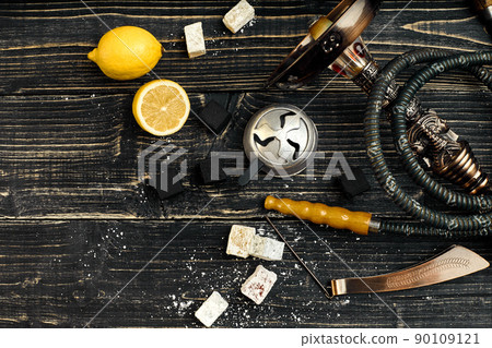 Dismantled parts of hookah on a wooden background with lemon fru Dismantled parts of hookah on a wooden background with lemon fru 90109121