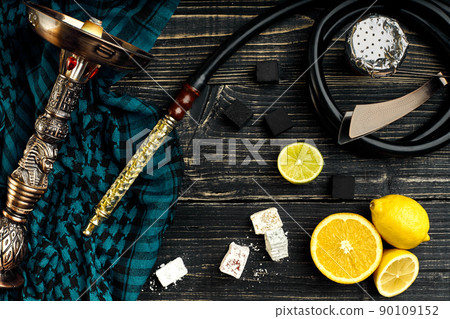 Top view of Hookah with orange fruit on a wooden background 90109152
