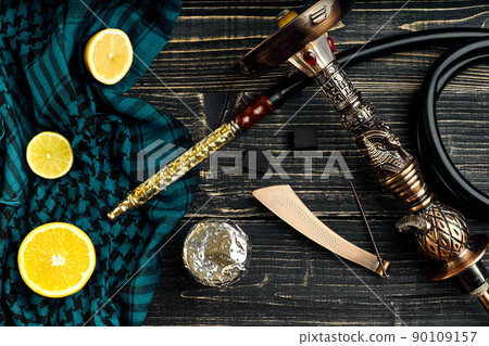 Top view of Hookah with orange fruit on a wooden background 90109157