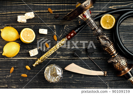 Dismantled parts of hookah on a wooden background with lemon fru 90109159
