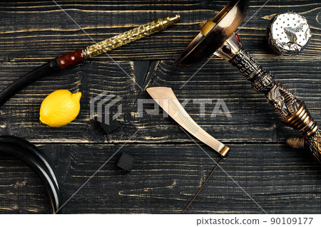 Dismantled parts of hookah on a wooden background with lemon fru 90109177
