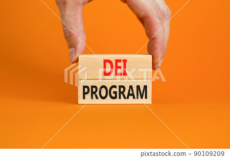 DEI diversity equity inclusion program symbol. Blocks with words DEI program on beautiful orange background. Business DEI diversity equity inclusion program concept. Copy space. 90109209