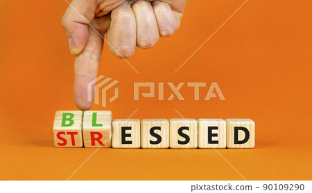 Blessed or stressed symbol. Businessman turns wooden cubes and changes the concept word Stressed to Blessed. Beautiful orange table orange background. Business blessed or stressed concept. Copy space. Blessed or stressed symbol. Businessman turns wooden cubes and changes the concept word Stressed to Blessed. Beautiful orange table orange background. Business blessed or stressed concept. Copy space. 90109290