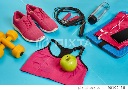 Flat lay of dumbbell, bottle of water, jump rope and sneaker, sport equipments, fitness items, top view 90109436