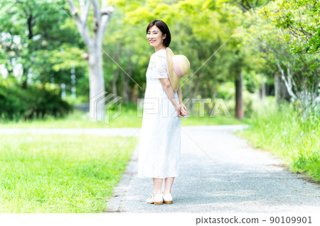 A young woman strolling through the fresh green A young woman strolling through the fresh green 90109901