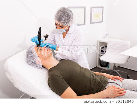 Man getting face ultrasound lifting procedure Man getting face ultrasound lifting procedure 90111846