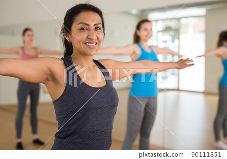 Portrait of young smiling hispanic woman dancing Portrait of young smiling hispanic woman dancing 90111851