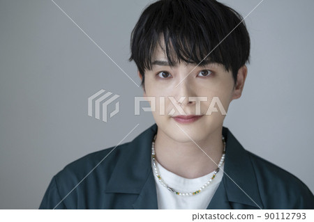 A man in his twenties looking at the camera portrait 90112793