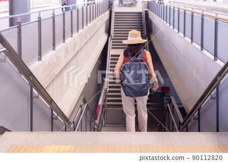 Woman passenger walking on staircase at train station,Transport insurance concept Woman passenger walking on staircase at train station,Transport insurance concept 90112820