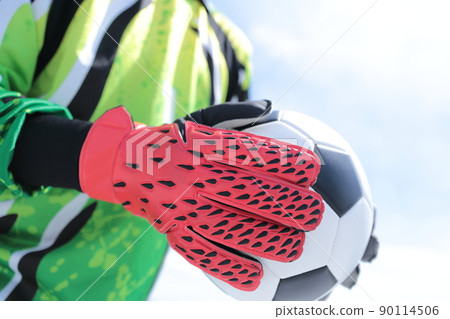 Goalkeeper man catching a soccer ball 90114506