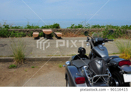 A black sidecar standing in a parking lot with a view of the sea 90116415