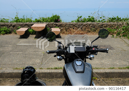 A black sidecar standing in a parking lot with a view of the sea A black sidecar standing in a parking lot with a view of the sea 90116417