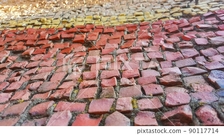 Multi-colored pavement of small stones, beautiful blur in warm colors Multi-colored pavement of small stones, beautiful blur in warm colors 90117714