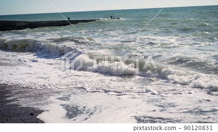 big splashing ocean wave rushes towards the coast of an exotic island in the sunny Pacific. Sea wave in slow motion. 90120831