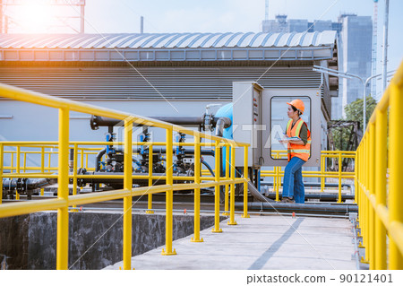Worker under checking the  waste water treatment pond industry large to control water support industry  90121401
