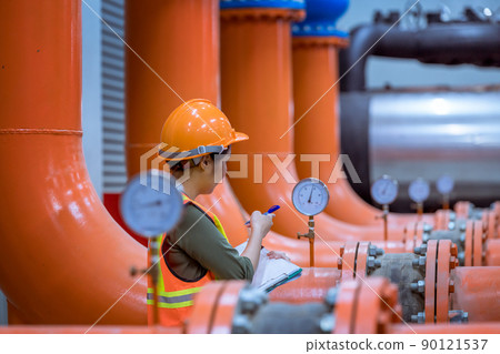 Industry engineer under checking the industry cooling tower air conditioner is water cooling tower air chiller HVAC of large industrial building to control air system. Industry engineer under checking the industry cooling tower air conditioner is water cooling tower air chiller HVAC of large industrial building to control air system. 90121537