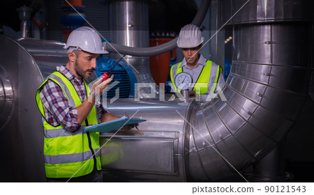 Industry engineer under checking the industry cooling tower air conditioner is water cooling tower air chiller HVAC of large industrial building to control air system. 90121543