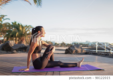 Beautiful girl stretching outdoors after exercising. Beautiful girl stretching outdoors after exercising. 90122015