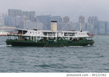 Star ferry sailing through Victoria Bay in Hong Kong 90122362