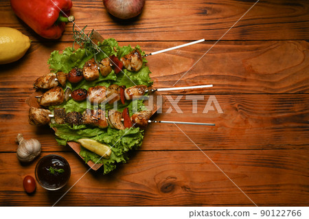 Grilled meat, vegetables and barbecue sauce on rustic wooden table. Barbecue, food, party concept 90122766