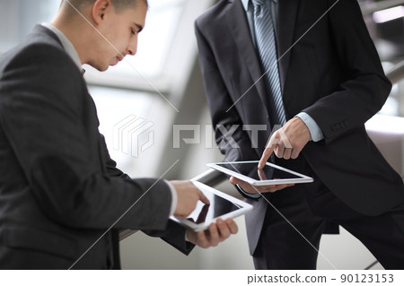 close up. two businessmen with tablet computers 90123153