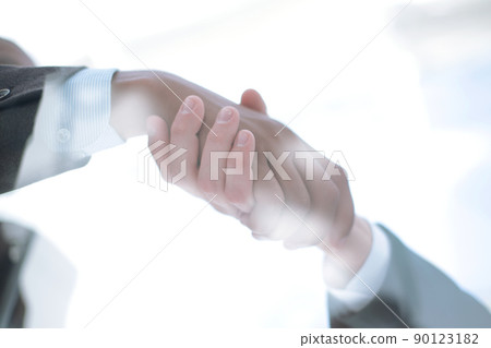 business background. handshake of business partners above the Desk. 90123182