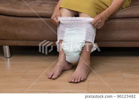 Urinary Incontinence in elderly and changing diaper. 90123482