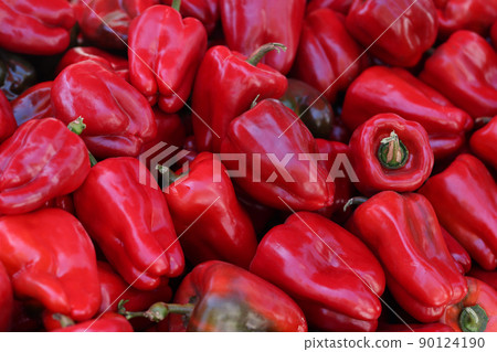 New crop of juicy red sweet peppers on market closeup New crop of juicy red sweet peppers on market closeup 90124190