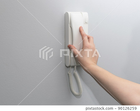 Hands opening door through intercom Hands opening door through intercom 90126259