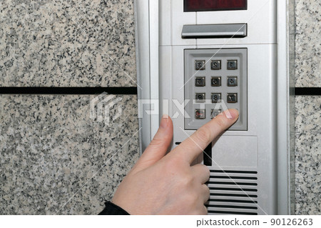 Hands Pressing on Intercom Hands Pressing on Intercom 90126263