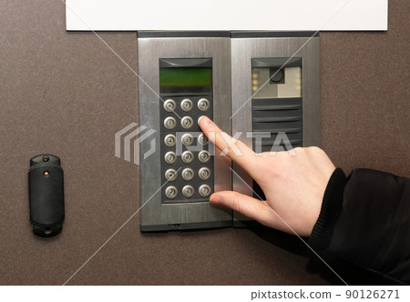 Hands Pressing on Intercom Hands Pressing on Intercom 90126271