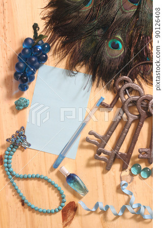 Notepaper and Pen on Table Surrounded By Peacock Feathers and Jewelry Notepaper and Pen on Table Surrounded By Peacock Feathers and Jewelry 90126408