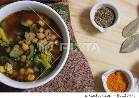 Garbanzo Beans With Zucchini and Broccoli With Spices on Rustic Table Garbanzo Beans With Zucchini and Broccoli With Spices on Rustic Table 90126473