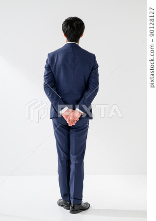 A backward-looking businessman man in a suit A backward-looking businessman man in a suit 90128127