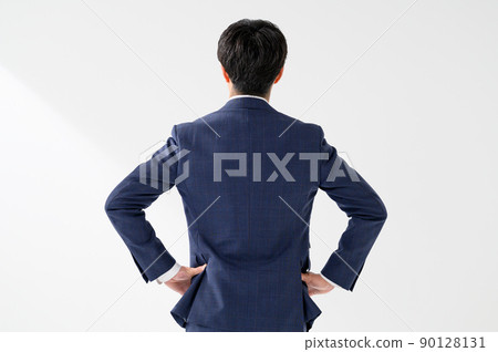 A backward-looking businessman man in a suit A backward-looking businessman man in a suit 90128131