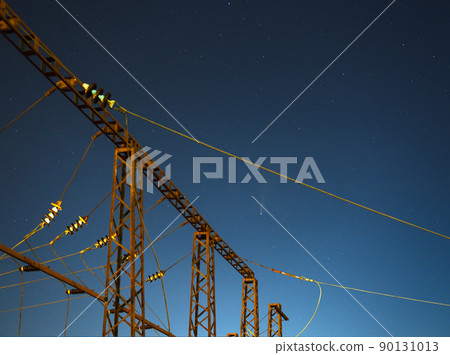 Comet Neowise C2020 F3 as it flies overhead in the summer sky over electric lines in Lviv City, Ukraine. 90131013