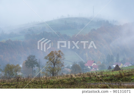 Cloudy and foggy autumn mountains scene. Peaceful picturesque traveling, seasonal, nature and countryside beauty concept scene. Carpathian Mountains, Ukraine. Cloudy and foggy autumn mountains scene. Peaceful picturesque traveling, seasonal, nature and countryside beauty concept scene. Carpathian Mountains, Ukraine. 90131071