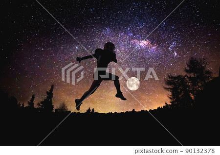 player football man jumping at the night starry sky background. Mixed media 90132378