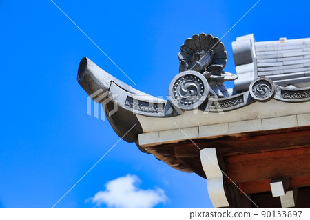 Clear blue sky and tiled roof of old building 90133897