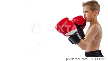 Closeup image of little male boxer in red boxing gloves posing isolated on white studio background. Concept of sport, movement, studying, achievements 90134485