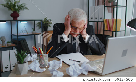 Senior business office man use laptop throwing crumpled paper, having nervous breakdown at work Senior business office man use laptop throwing crumpled paper, having nervous breakdown at work 90134500