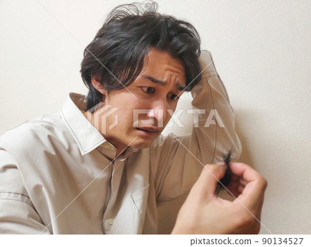 A man depressed by hair loss A man depressed by hair loss 90134527