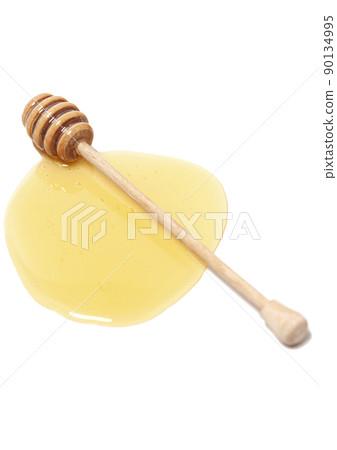 Wooden dipper with honey isolated on a white background. Golden organic floral honey natural. Wooden dipper with honey isolated on a white background. Golden organic floral honey natural. 90134995